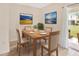 Light-filled dining room with wood table and chairs and sliding glass doors to the patio at 12710 Buffalo Run Drive, Gibsonton, FL 33534
