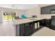 Modern kitchen showcasing black appliances, bright countertops, and a sliding door to the backyard at 12710 Buffalo Run Drive, Gibsonton, FL 33534