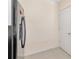 Kitchen featuring stainless steel refrigerator and a white door leading to additional storage or pantry at 12710 Buffalo Run Drive, Gibsonton, FL 33534