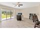 Open-concept living room with water views, wood floors, and sliding glass doors to bring in lots of light at 12710 Buffalo Run Drive, Gibsonton, FL 33534
