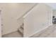 Interior shot of carpeted stairway with white railing and adjacent doorway at 12710 Buffalo Run Drive, Gibsonton, FL 33534