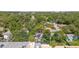 Overhead view of the property amidst lush trees, highlighting the residential setting at 1327 S Michigan Ave, Clearwater, FL 33756