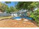 Backyard with lush trees and a building with green siding, enhancing the setting at 1327 S Michigan Ave, Clearwater, FL 33756