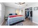 This bedroom has a ceiling fan, a comfy bed, and a closet filled with clothes and storage boxes at 1327 S Michigan Ave, Clearwater, FL 33756