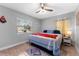 Cozy bedroom with a ceiling fan, rug, and a bright window overlooking the exterior at 1327 S Michigan Ave, Clearwater, FL 33756
