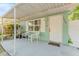 Inviting covered front porch with seating area, light-green siding, and a white front door at 1327 S Michigan Ave, Clearwater, FL 33756