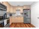 Well-equipped kitchen with stainless steel appliances, wood cabinets, and laminate flooring at 1327 S Michigan Ave, Clearwater, FL 33756