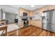 Contemporary kitchen featuring stainless steel appliances, wooden cabinets, and laminate flooring at 1327 S Michigan Ave, Clearwater, FL 33756