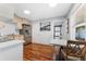 Modern kitchen featuring stainless steel appliances, wood cabinets, and a dining area with seating at 1327 S Michigan Ave, Clearwater, FL 33756