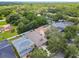 Stunning aerial view of a neighborhood surrounded by mature trees, close to everything in a desirable location at 13310 Tiger Lilly Ln, Tampa, FL 33625