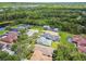 Residential aerial view showcasing homes, mature trees, and a quiet cul-de-sac in a desirable neighborhood at 13310 Tiger Lilly Ln, Tampa, FL 33625