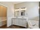 Bathroom with double vanity sinks, soaking tub, and ample lighting at 13310 Tiger Lilly Ln, Tampa, FL 33625
