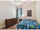 Cozy bedroom with hardwood floors, a themed bed, and a window, creating a comfortable and inviting space at 13310 Tiger Lilly Ln, Tampa, FL 33625