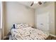 Bedroom with ceiling fan, wood-look flooring, and flower patterned bedding at 13310 Tiger Lilly Ln, Tampa, FL 33625