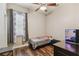 Bedroom with ceiling fan, wood-look flooring, and aquarium at 13310 Tiger Lilly Ln, Tampa, FL 33625