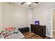 Bedroom with ceiling fan, wood-look flooring, and aquarium at 13310 Tiger Lilly Ln, Tampa, FL 33625