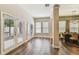 A naturally lit dining space shows wood floors, lots of light, and views of the exterior at 13310 Tiger Lilly Ln, Tampa, FL 33625