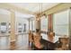 Bright dining room with lots of windows, light wood floors, and a wooden table at 13310 Tiger Lilly Ln, Tampa, FL 33625