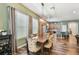 Dining room with a view into the kitchen, featuring a long wooden table with decorative chairs at 13310 Tiger Lilly Ln, Tampa, FL 33625