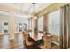 Dining room features a large table, decorative lighting, and wood-look flooring at 13310 Tiger Lilly Ln, Tampa, FL 33625