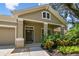 Charming exterior elevation with well-maintained landscaping and welcoming front porch, enhancing curb appeal at 13310 Tiger Lilly Ln, Tampa, FL 33625