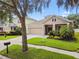 Charming single-Gathering home featuring a well-maintained lawn and a two-car garage at 13310 Tiger Lilly Ln, Tampa, FL 33625