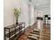 Hallway with decor shelf and bamboo plant, with an arched entrance into the Gathering room, showcasing the open floor plan at 13310 Tiger Lilly Ln, Tampa, FL 33625