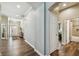 Hallway leading to the front door, with an open arched entry into the main part of the house and doors to the rooms at 13310 Tiger Lilly Ln, Tampa, FL 33625