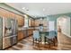 Kitchen featuring stainless appliances, a large island, and wood floors at 13310 Tiger Lilly Ln, Tampa, FL 33625