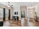 Open-concept living room showcasing wood-look floors, natural light, and a seamless flow to other spaces at 13310 Tiger Lilly Ln, Tampa, FL 33625