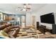 Open living room and kitchen design with hardwood floors, stainless appliances, and large sofa at 13310 Tiger Lilly Ln, Tampa, FL 33625