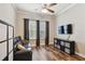 Relaxing living room with hardwood floors, decorative window treatments, and a comfortable sofa for cozy nights at 13310 Tiger Lilly Ln, Tampa, FL 33625