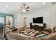Cozy living room with a large TV and comfortable seating area at 13310 Tiger Lilly Ln, Tampa, FL 33625