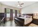 Comfortable bedroom with ample natural light, hardwood floors, and traditional furnishings at 13310 Tiger Lilly Ln, Tampa, FL 33625