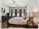 Main bedroom showcases a ceiling fan, three windows and wood floors, creating a relaxing space at 13310 Tiger Lilly Ln, Tampa, FL 33625
