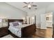 Main bedroom with wood floors, ceiling fan, and access to the Primary bath at 13310 Tiger Lilly Ln, Tampa, FL 33625