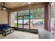 Covered patio featuring ceiling fans, outdoor furniture, and a view of the backyard playset at 13310 Tiger Lilly Ln, Tampa, FL 33625