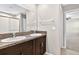 This is a bathroom with a vanity that has a double sink with granite countertop and a bath tub at 13324 Willow Bluestar Loop, Riverview, FL 33579
