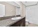 This is a bathroom with a vanity that has a granite countertop and a bath tub at 13324 Willow Bluestar Loop, Riverview, FL 33579