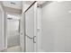 Bathroom shower features white tiles and a glass door, offering a clean and modern aesthetic at 13324 Willow Bluestar Loop, Riverview, FL 33579