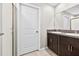 Bathroom features double sinks with granite countertops and dark wood cabinets at 13324 Willow Bluestar Loop, Riverview, FL 33579