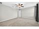 This is a bedroom with neutral carpeting, ceiling fan and a window with dark curtains at 13324 Willow Bluestar Loop, Riverview, FL 33579