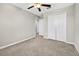 This is a bedroom with neutral carpeting and a walk-in closet with a light at 13324 Willow Bluestar Loop, Riverview, FL 33579
