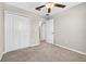 This is a bedroom with neutral carpeting and a walk-in closet with a light at 13324 Willow Bluestar Loop, Riverview, FL 33579