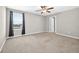 This is a bedroom with neutral carpeting and a view of a neighborhood through a window at 13324 Willow Bluestar Loop, Riverview, FL 33579