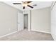 This is a bedroom with neutral carpeting and a walk-in closet with a light at 13324 Willow Bluestar Loop, Riverview, FL 33579