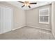 This is a bedroom with neutral carpeting, ceiling fan and a window with horizontal blinds at 13324 Willow Bluestar Loop, Riverview, FL 33579