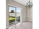 Dining area features sliding glass doors opening to a backyard and a modern light fixture at 13324 Willow Bluestar Loop, Riverview, FL 33579