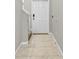 Clean and bright entryway with tile flooring and a white front door, adjacent to a staircase at 13324 Willow Bluestar Loop, Riverview, FL 33579