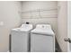 Laundry room with a washer and dryer set and a wire shelf, maximizing space efficiency at 13324 Willow Bluestar Loop, Riverview, FL 33579